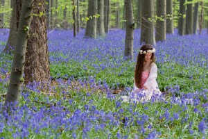 Innocent young woman with pink fairy dress in a springtime blueb