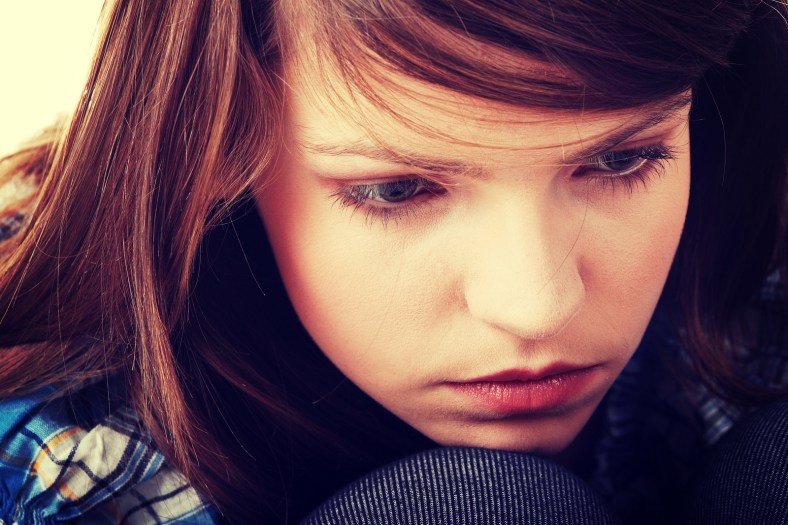 Teenage girl depression - lost love - isolated on white backgrou